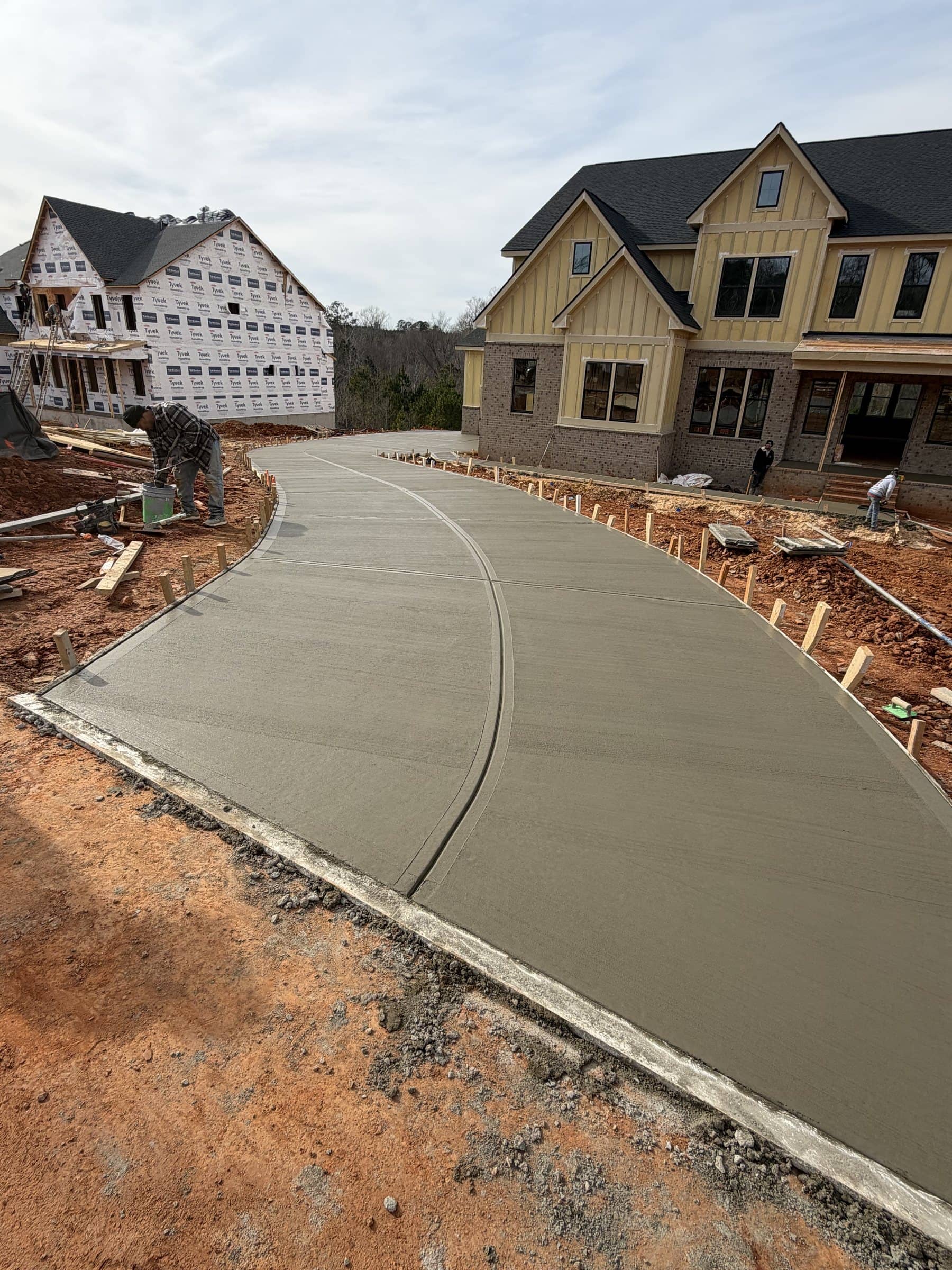 Freshly poured curved concrete driveway at a new home in Fuquay-Varina, NC