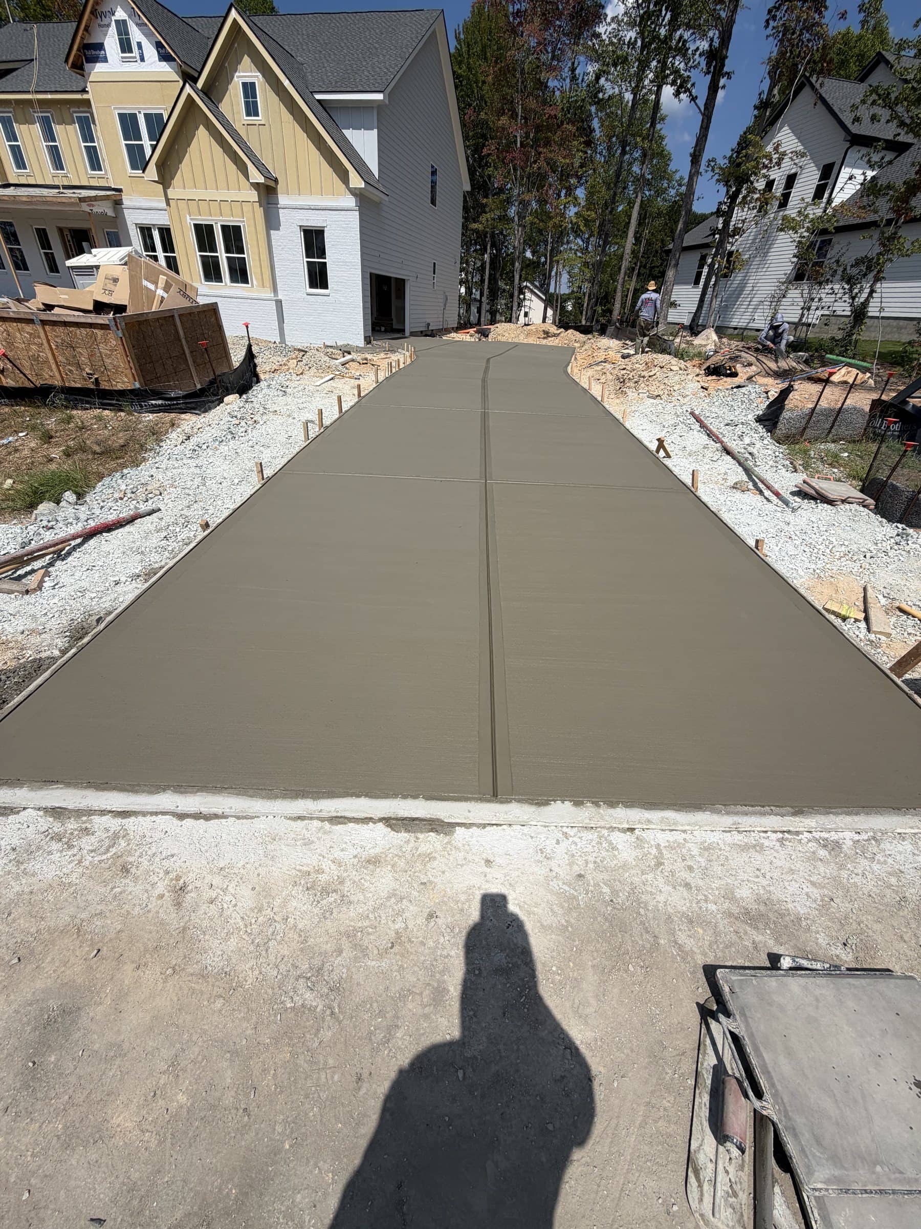 Long straight driveway poured at a new-construction home